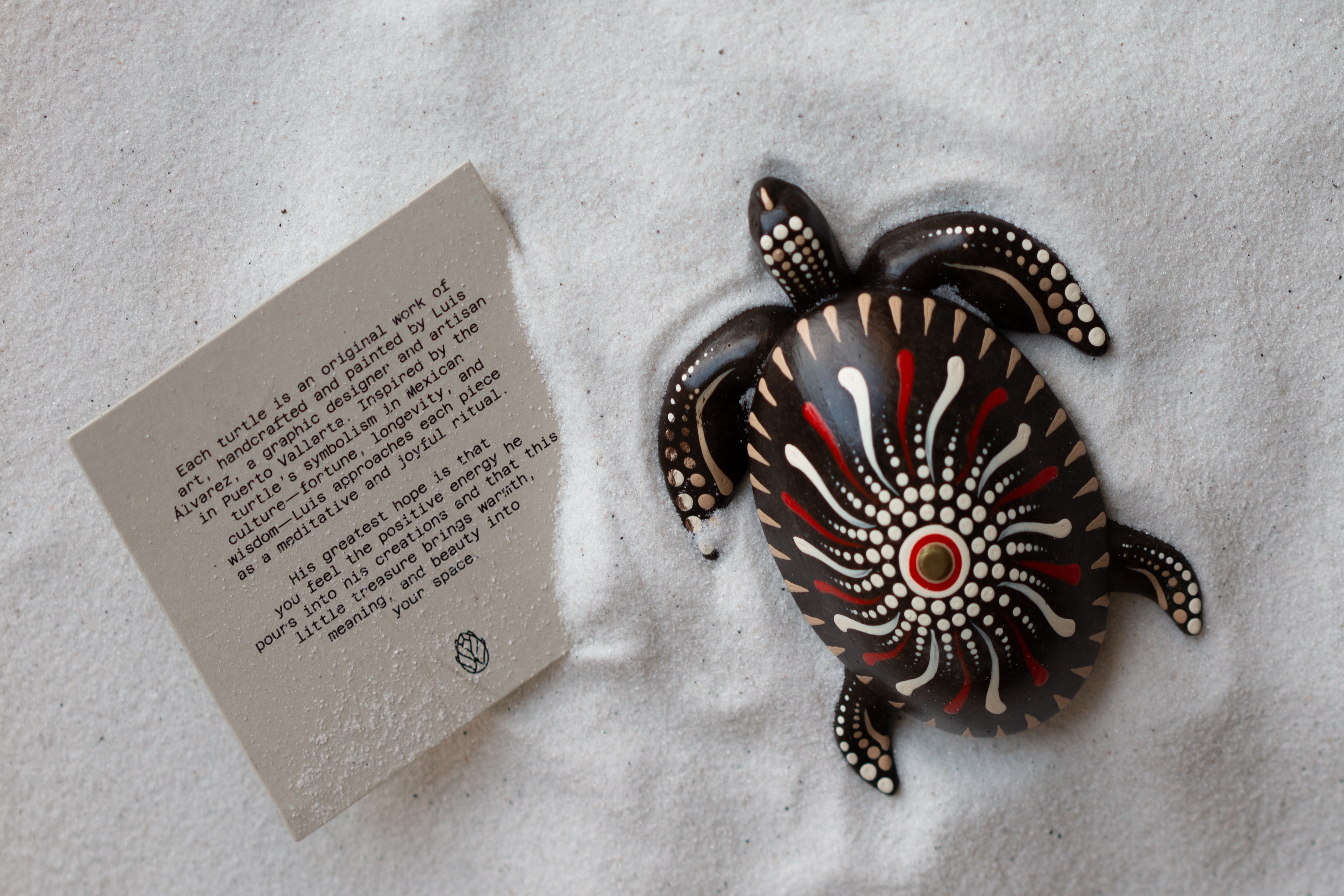 Decorative turtle-shaped object on sand Petit Joys artisanal goods