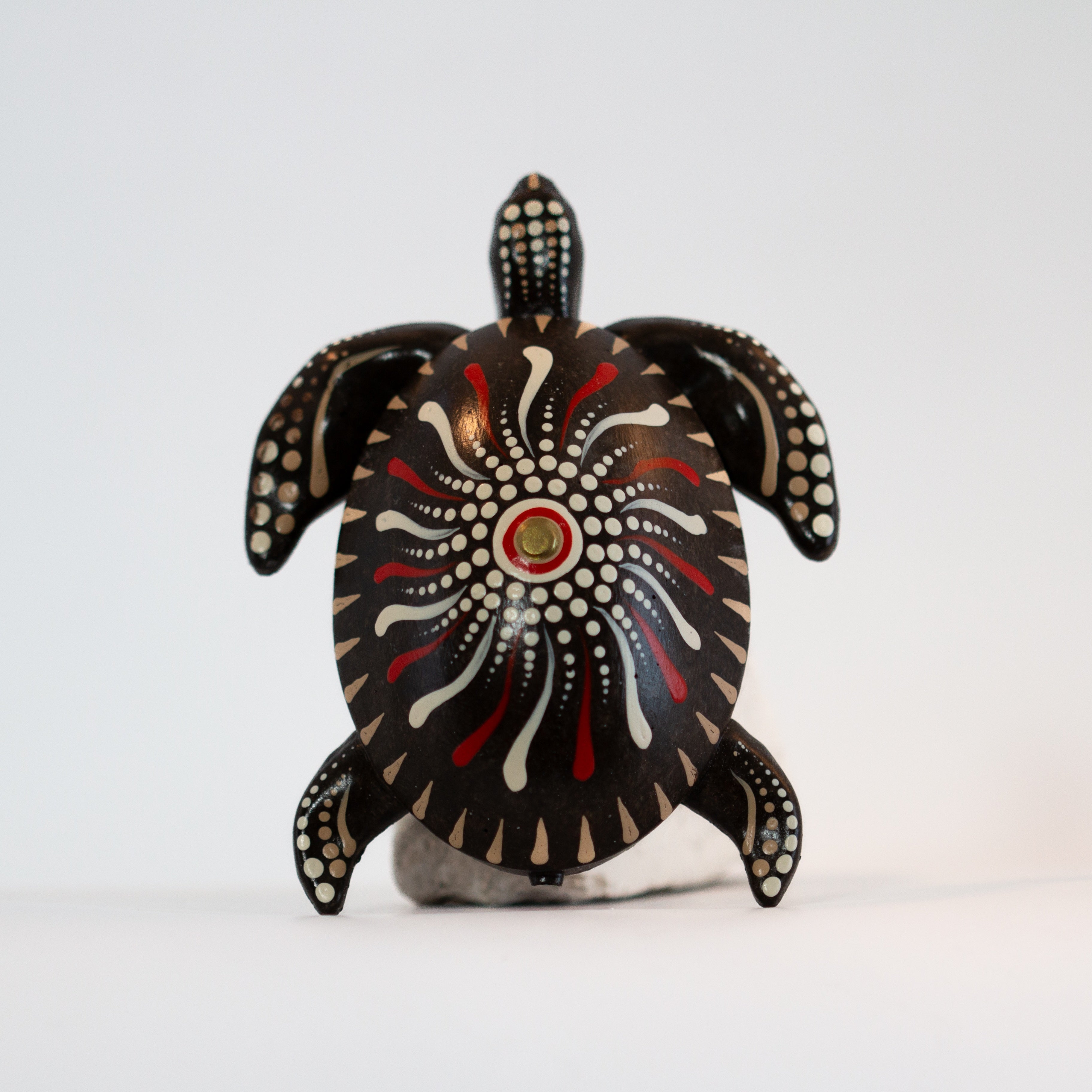 Decorative turtle-shaped object on sand Petit Joys artisanal goods
